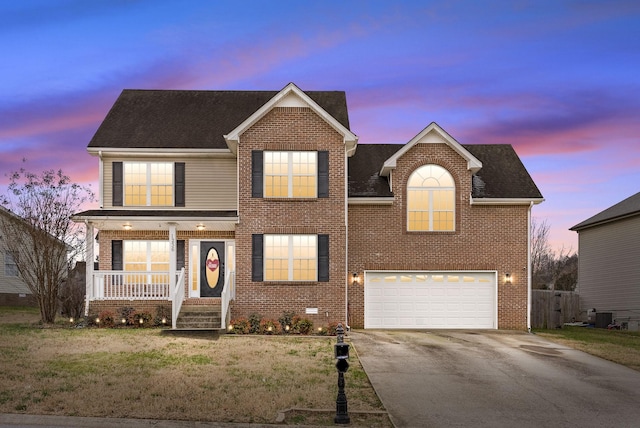 traditional-style house with driveway, crawl space, an attached garage, a porch, and brick siding