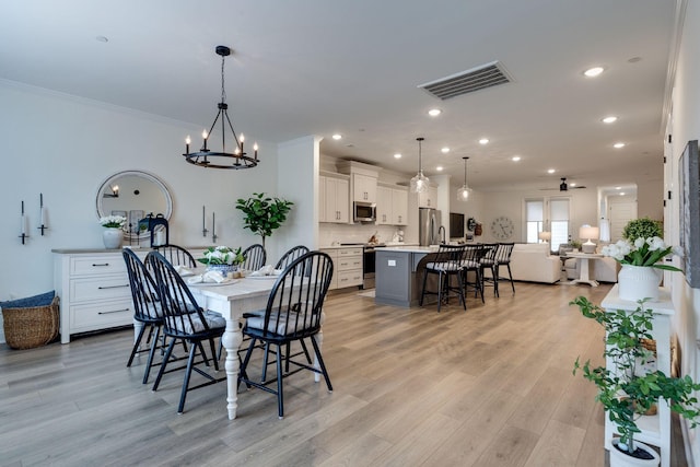 dining room featuring recessed lighting, visible vents, crown molding, light wood-style floors, and ceiling fan with notable chandelier