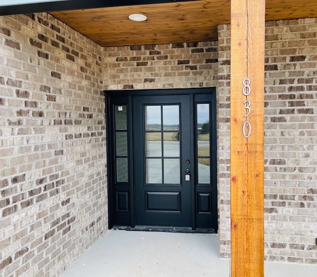 property entrance with brick siding