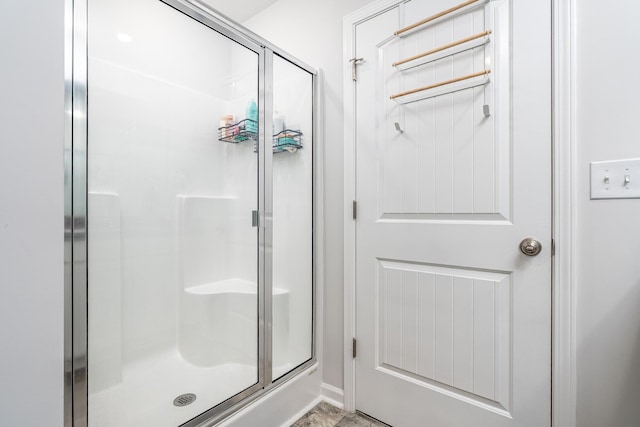 full bath featuring a shower stall