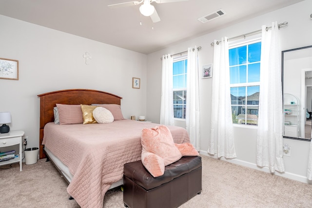 bedroom with light colored carpet, visible vents, ceiling fan, and baseboards