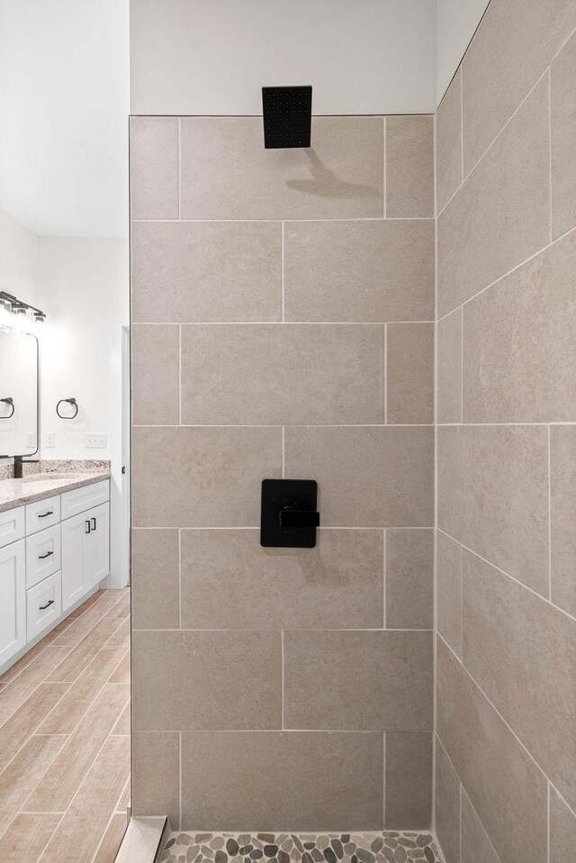 bathroom featuring walk in shower and vanity