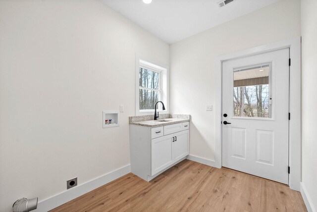 washroom with plenty of natural light, hookup for a washing machine, cabinet space, and hookup for an electric dryer