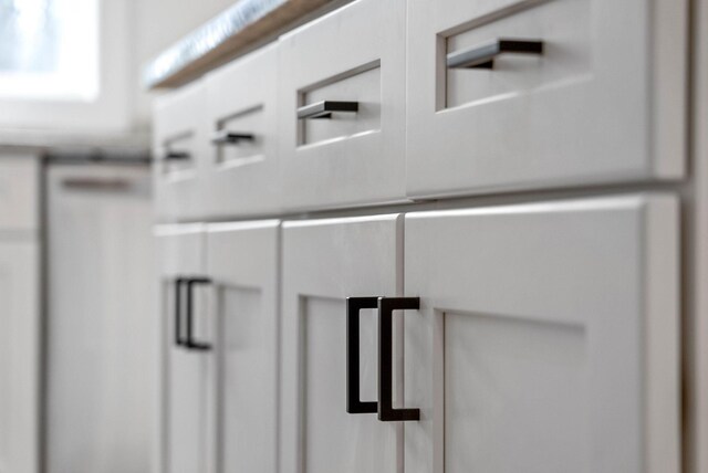 details featuring light countertops, mail area, and white cabinets