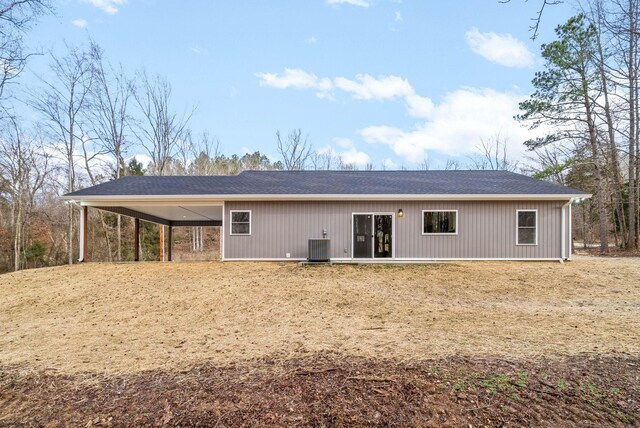 rear view of property with a carport