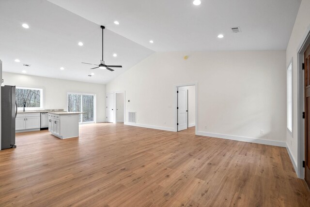 unfurnished living room with a ceiling fan, light wood-type flooring, and visible vents