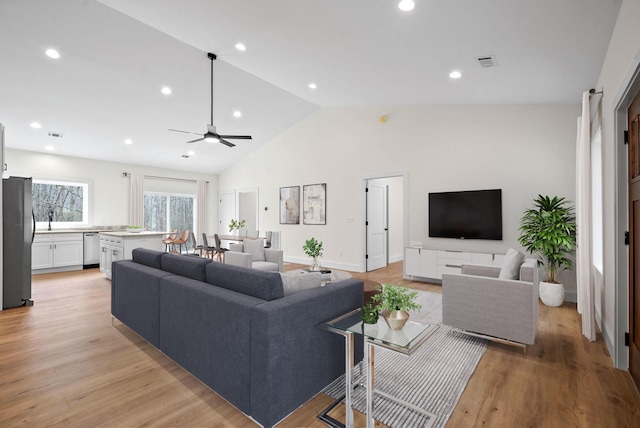 living area with recessed lighting, visible vents, ceiling fan, high vaulted ceiling, and light wood-type flooring