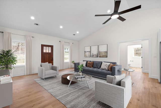 living room featuring light wood finished floors, plenty of natural light, and visible vents