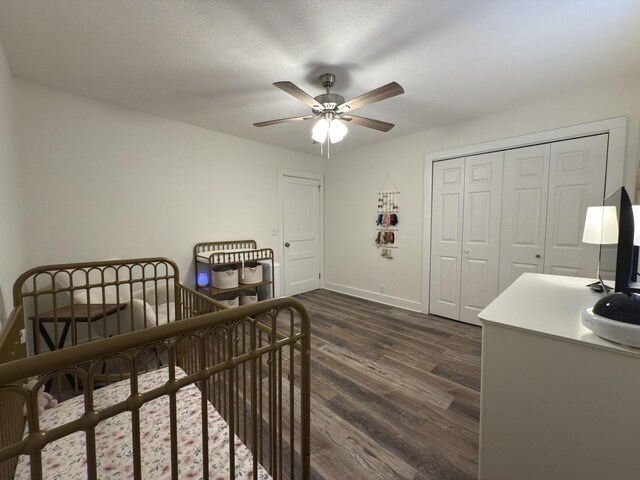 bedroom featuring a closet, dark wood-type flooring, ceiling fan, a textured ceiling, and baseboards