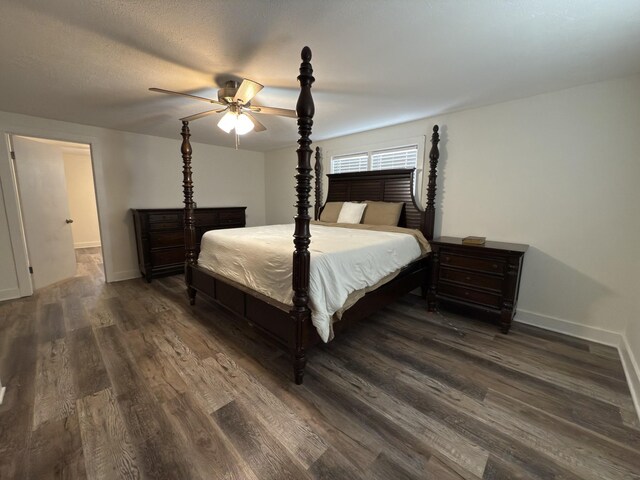 bedroom featuring dark wood-style floors, ceiling fan, and baseboards