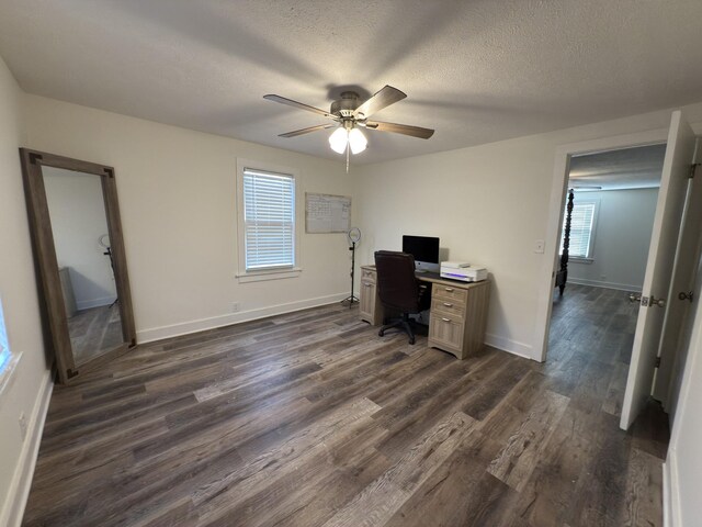 office featuring ceiling fan, a textured ceiling, baseboards, and dark wood-type flooring