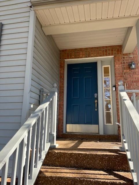 property entrance with brick siding