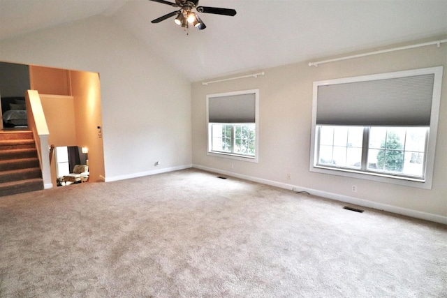 unfurnished room with baseboards, visible vents, stairs, vaulted ceiling, and carpet floors