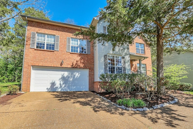 traditional-style home with an attached garage, concrete driveway, and brick siding