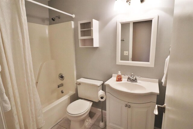 bathroom featuring toilet, shower / bath combo, vanity, and tile patterned floors