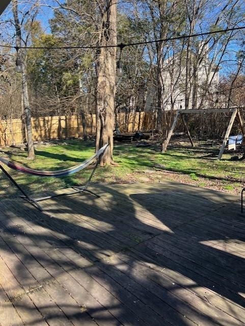 view of yard with a deck and fence