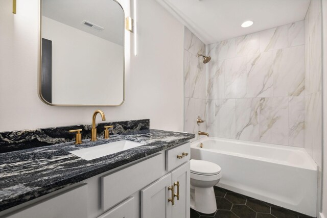 full bath featuring visible vents, shower / bathing tub combination, toilet, vanity, and tile patterned floors