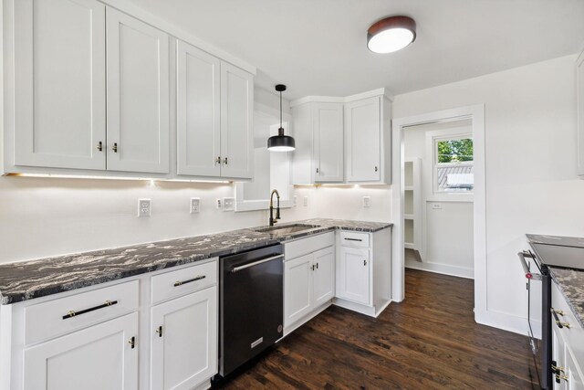 kitchen featuring hanging light fixtures, appliances with stainless steel finishes, white cabinets, and a sink