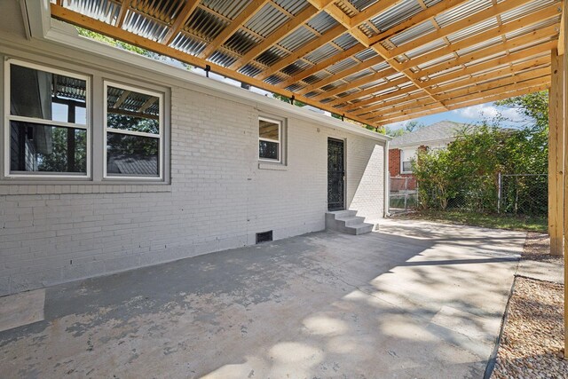 view of patio / terrace featuring entry steps, fence, and visible vents