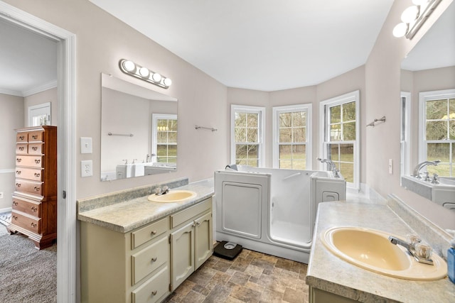 bathroom featuring stone finish flooring, two vanities, and a sink