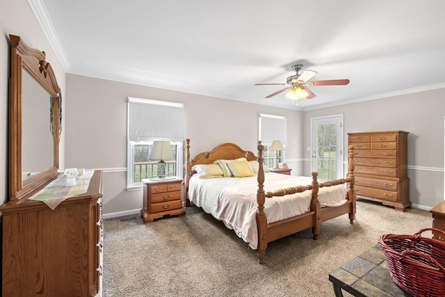 carpeted bedroom with a ceiling fan, crown molding, and baseboards