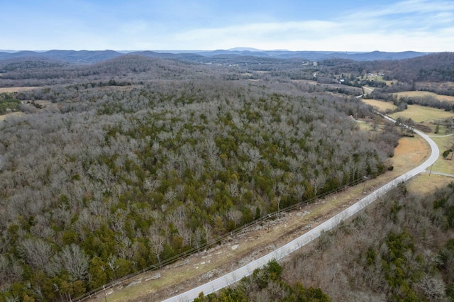 drone / aerial view featuring a forest view and a mountain view