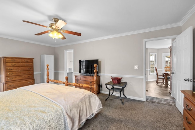 carpeted bedroom featuring a ceiling fan, baseboards, and crown molding