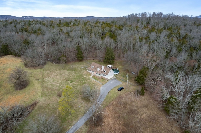 birds eye view of property featuring a view of trees