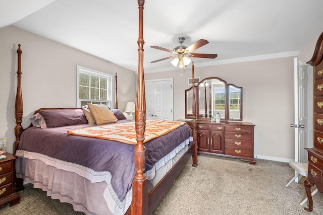 bedroom with ceiling fan, light colored carpet, visible vents, baseboards, and ornamental molding