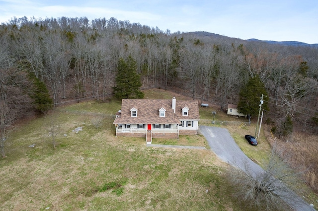 birds eye view of property featuring a forest view and a mountain view