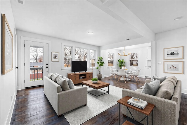 living area with baseboards, dark wood-style flooring, and a notable chandelier