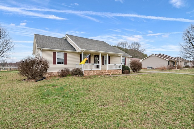 ranch-style home with a porch, roof with shingles, and a front lawn