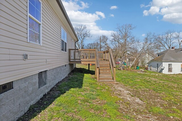 view of yard with a deck and stairway