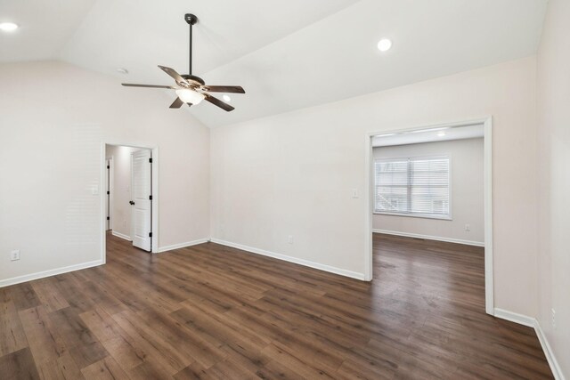 unfurnished room with dark wood-type flooring, vaulted ceiling, and baseboards