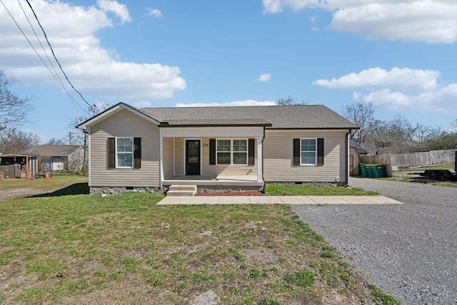 view of front facade featuring crawl space, covered porch, fence, and a front lawn