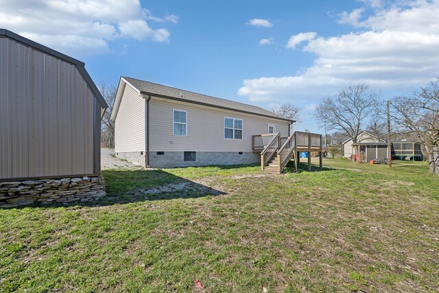 rear view of house with stairs, a yard, a deck, and crawl space