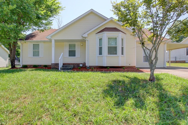 view of front of property with a carport, crawl space, driveway, and a front lawn