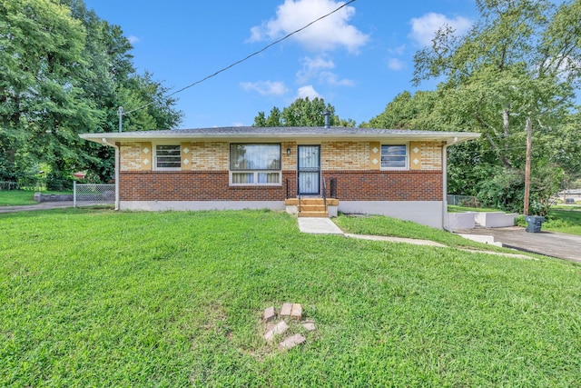 single story home featuring brick siding, a front lawn, and fence