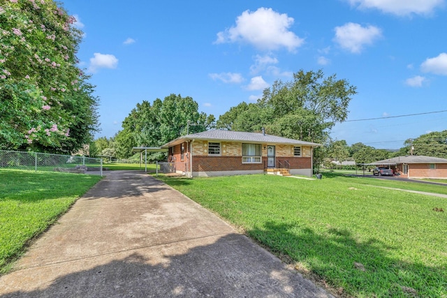 view of front facade with concrete driveway, brick siding, a front lawn, and fence