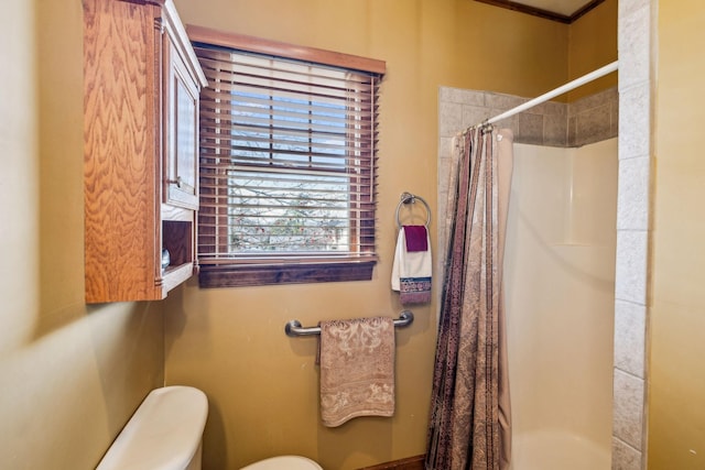 full bathroom with a shower stall and toilet