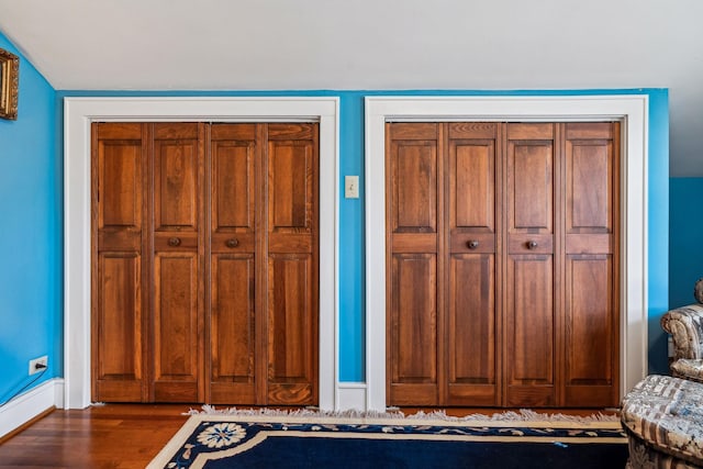 interior space featuring baseboards and wood finished floors