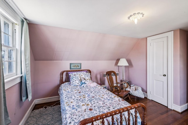 bedroom featuring vaulted ceiling, dark wood-type flooring, and baseboards