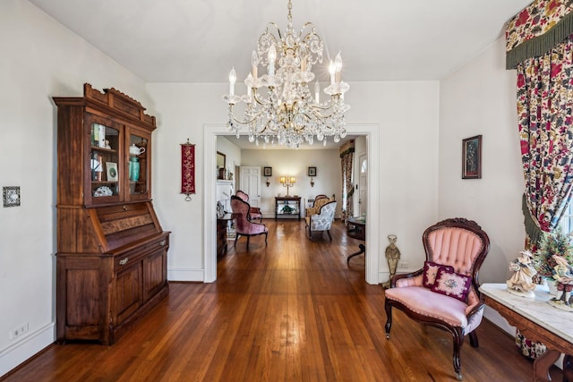 corridor featuring baseboards, a chandelier, and dark wood-style flooring