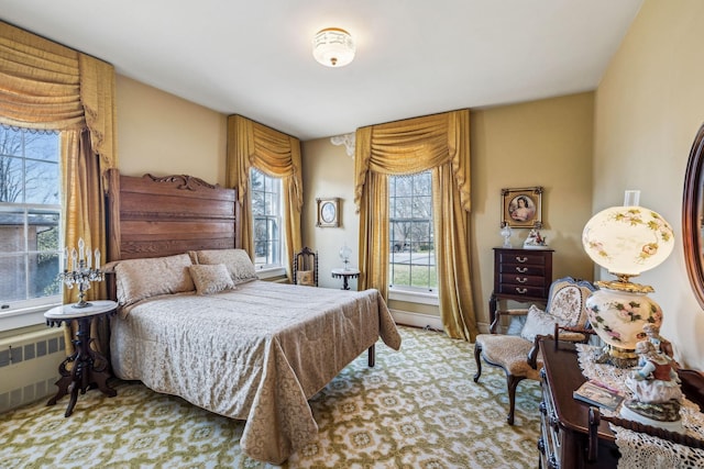 bedroom with light carpet and radiator