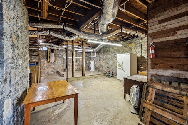 unfinished below grade area featuring electric panel, water heater, and white refrigerator with ice dispenser