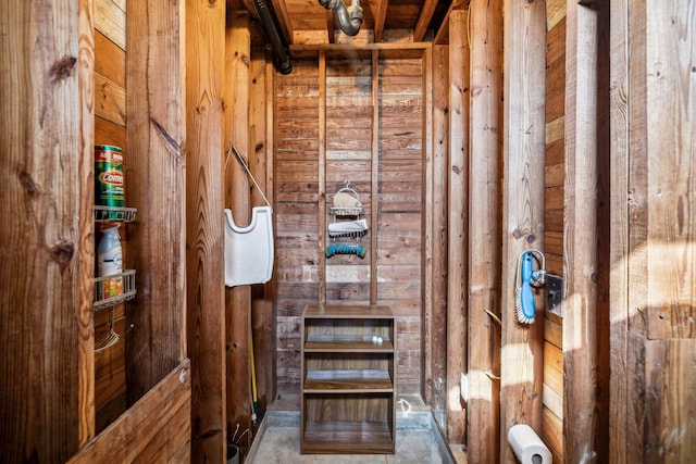 bathroom featuring wood walls