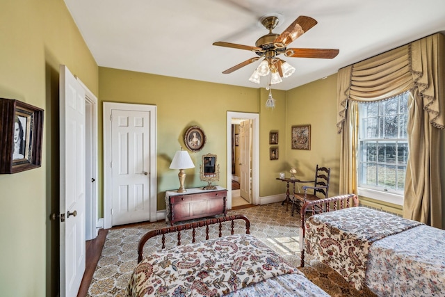 bedroom featuring a ceiling fan and baseboards