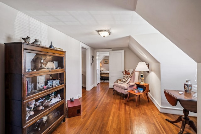 sitting room with baseboards and wood finished floors