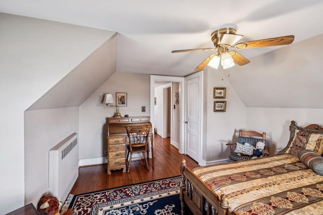 bedroom featuring baseboards, lofted ceiling, radiator heating unit, ceiling fan, and dark wood-style flooring