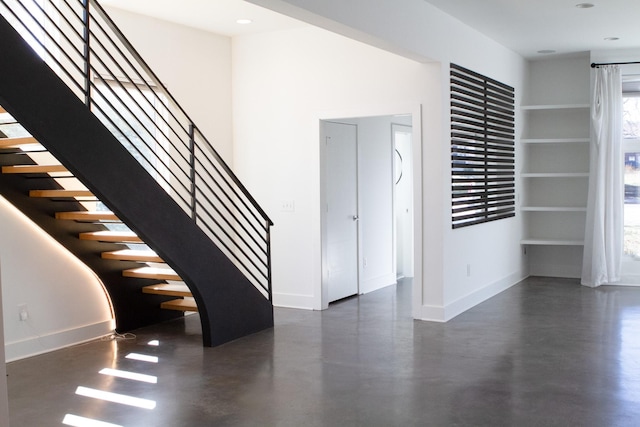 interior space featuring finished concrete flooring and baseboards